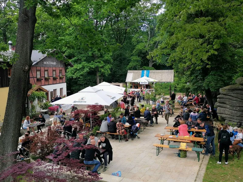 Voller Biergarten mit Bierbänken und Kiosk